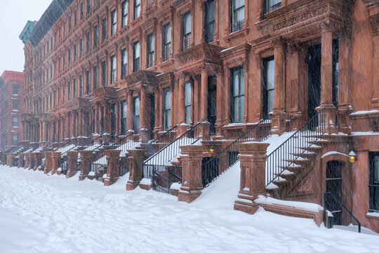Historic Harlem brownstone townhouses during a winter snowstorm in the Mount Morris Park Historic District, Manhattan, New York City, USA