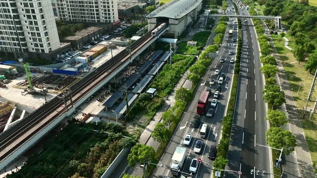 Descending Aerial View of Metro Train and Residential District in Shanghai