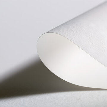 Curled corner of a paper document page with a shadow