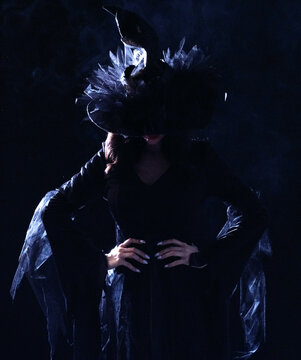 Beautiful witch in black Halloween hat