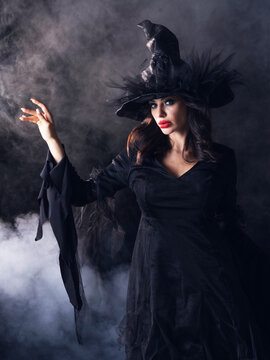 Beautiful witch in black Halloween hat