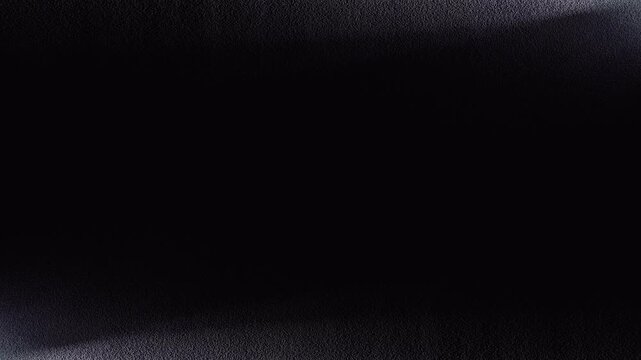 ざらざらした壁面を照らす2本のサーチライトのシームレスループ映像。ライトの動きのバリエーション