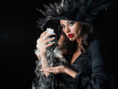 Beautiful witch in black Halloween hat