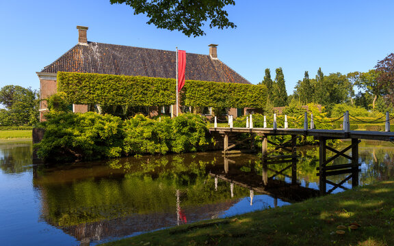 Frontside with bridge and moat of the beautiful noble house and estate Verhildersum, Leens, Groningen, the Netherlands
