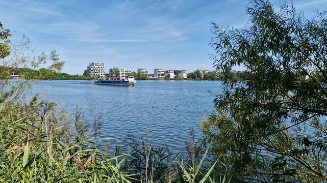 Passenger boat cruising on Ziegelinnensee lake in Schwerin, Germany