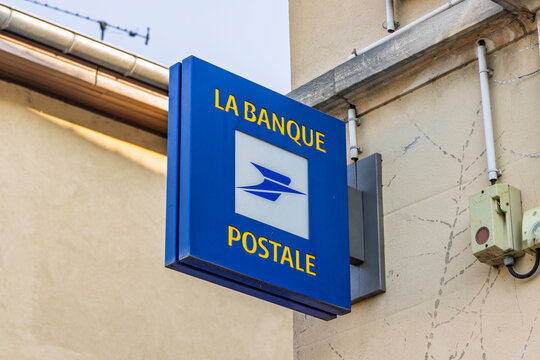 Montrevel-en-Bresse, France - July 30, 2026: Signboard of La Banque Postale, a French postal bank, attached to the facade of a building in a European village.