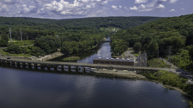 Aerial view of Stevenson Generating Station, a historic brick hydroelectric powerhouse and electrical switchyard situated along the Housatonic River in Monroe, CT, United States.
