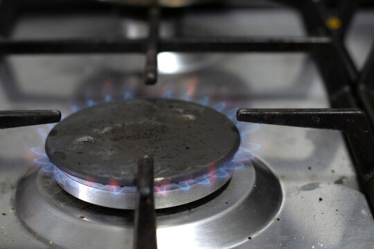 Gas Stove Burner with High Blue Flame in a Modern Kitchen