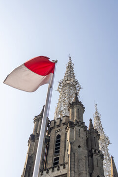The Cathedral of Our Lady of the Assumption stands beside the Indonesian flag,