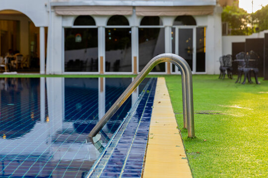 Ladder stainless handrails for descent into swimming pool.
