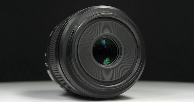 Black macro camera lens, video on black background