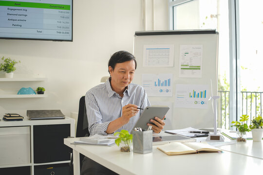 A diverse group of business professionals working together in a modern office, analyzing environmental data and charts to develop eco-friendly, sustainable corporate strategies.