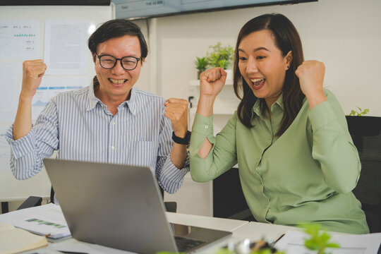 A diverse group of business professionals working together in a modern office, analyzing environmental data and charts to develop eco-friendly, sustainable corporate strategies.