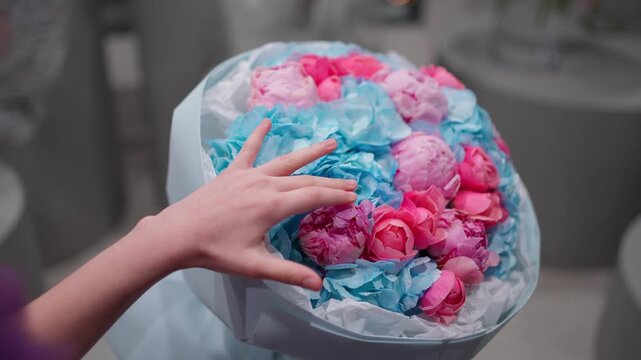 Woman received a colorful bouquet of hydrangeas and peonies as a gift. Concept of flower arrangement.