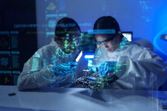 Engineers work in semiconductor or microchip labs in the electronics industry. Electronic engineers in computer technology, CPU maintenance, hardware, motherboard component upgrades.