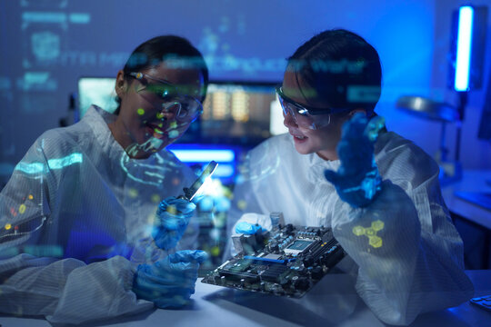 Engineers work in semiconductor or microchip labs in the electronics industry. Electronic engineers in computer technology, CPU maintenance, hardware, motherboard component upgrades.