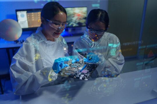 Engineers work in semiconductor or microchip labs in the electronics industry. Electronic engineers in computer technology, CPU maintenance, hardware, motherboard component upgrades.