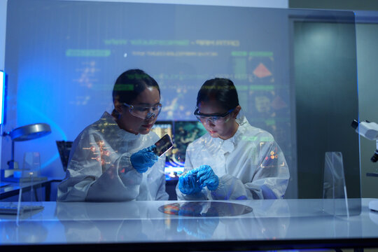 Engineers work in semiconductor or microchip labs in the electronics industry. Electronic engineers in computer technology, 