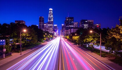 Obraz premium Street scene at night in a city showcasing captivating light trails from vehicles, concept of time
