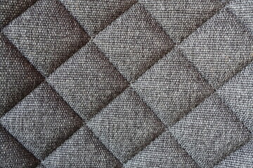 Naklejka premium Close up of gray quilted fabric texture with diamond pattern