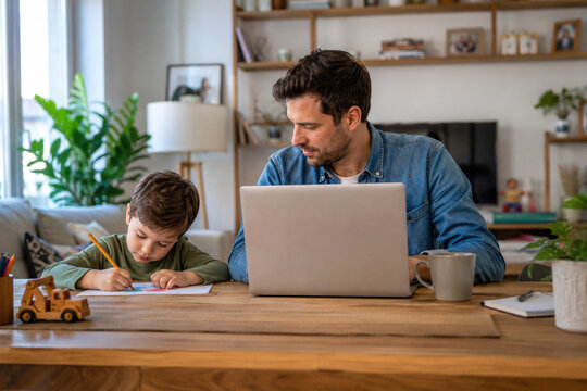 Father working from home while caring for his child, work-life balance, teleworking and parenting in a modern home