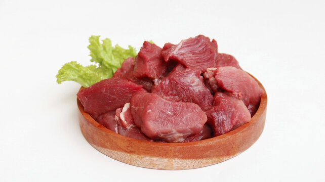 Raw organic slices beef on a wooden plate on white background