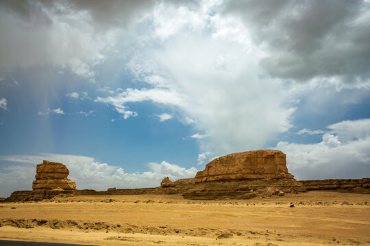 Yadan Landforms Near Northwest China U-shaped Highway: Wind-eroded Rock Pillars Stand Amid Gobi Under Sweeping Cloud Shadows