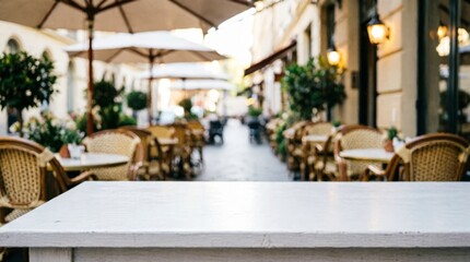 Obraz premium Outdoor Café Terrace with White Table and Wicker Chairs for Lifestyle Photography