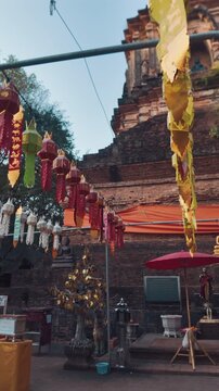 Buddhist Wat Lok Moli temple stupa with colorful hanging lanterns, Thai heritage architecture, Ancient pagoda with decorative ornate details, Chiang Mai, Thailand 4k vertical video