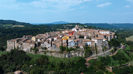 Obraz premium Orte ancient hilltop town aerial drone view Lazio Italy medieval stone houses red tiled roofs green landscape sunny summer vacation European travel
