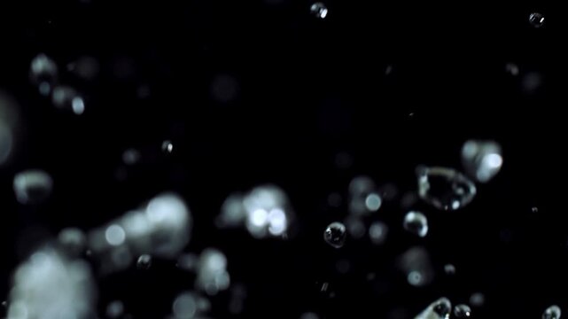 Slow Motion Water Droplets Suspended in Air Against Black