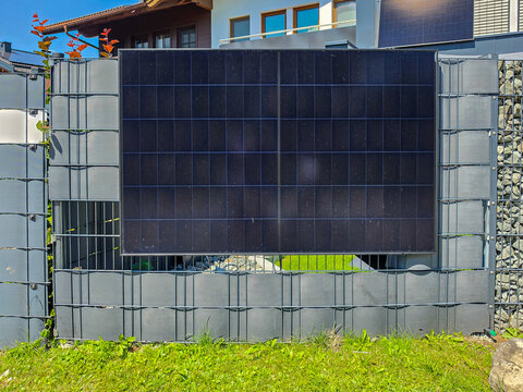 Stone and metal fence with solar panel