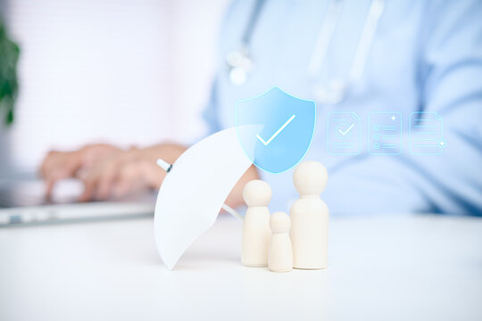 Family figures with umbrella symbolizing, shield, health insurance coverage, medical protection, and financial support for healthcare and wellbeing, Business professional with Stethoscope using laptop