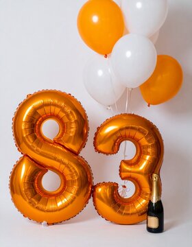Number 83 Balloon with Champagne Bottle. Orange and White Theme for Birthday or Anniversary Celebration