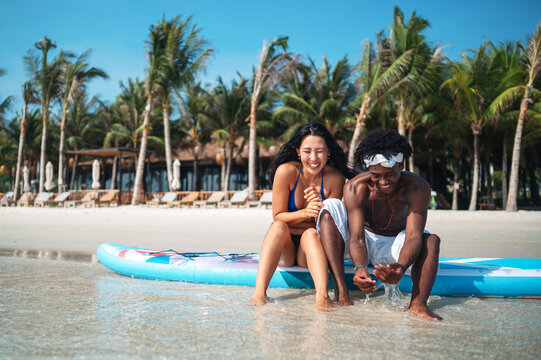 Interracial couple enjoying a romantic beach getaway, embracing love, laughter, and togetherness