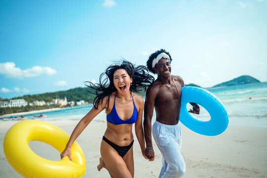 Romantic young couple enjoying their tropical honeymoon on a beautiful sunny beach