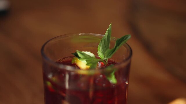 Close up of a glass of chicha morada, a traditional peruvian purple corn drink, on a wooden table