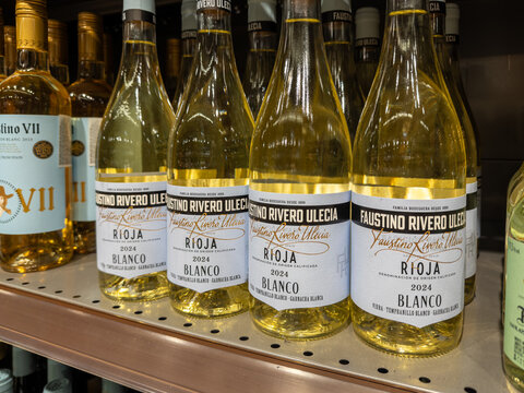Kyiv, Ukraine - March 14, 2026: Faustino Rivero Ulecia white wine bottles lined up on a supermarket shelf for sale, representing a retail selection of dry Spanish Rioja vintage drink