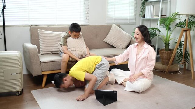 Happy mother spending quality time with two children at home