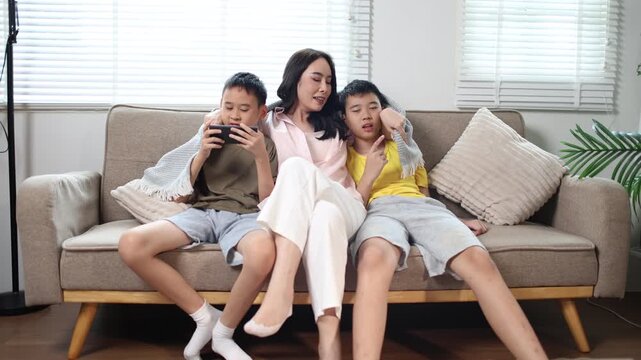 Happy mother spending quality time with two children at home