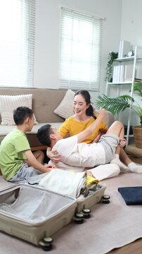 Mother and children using tablet together at home