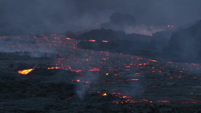 Volcanic eruption in Iceland 2023 at night. Magma flowing down a valley.