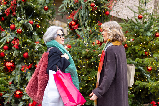 Senior women friends enjoying christmas shopping season
