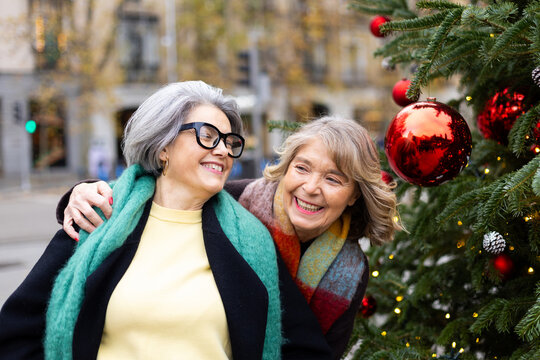 Senior women friends laughing celebrating christmas holiday