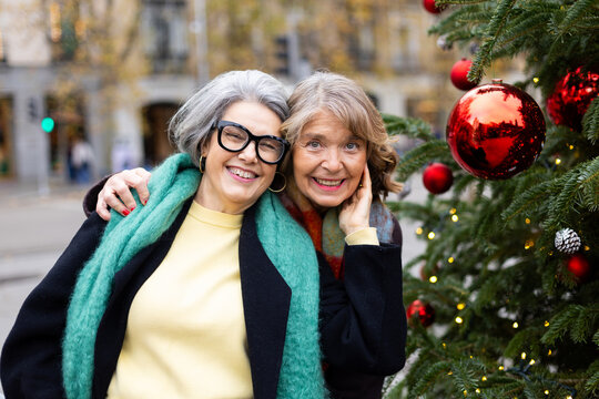 Senior women friends celebrating christmas holiday feeling happy