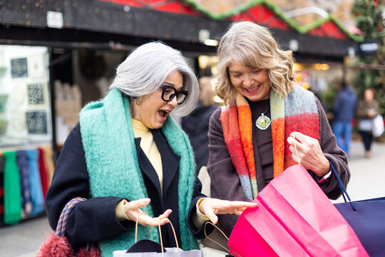 Senior women enjoying shopping at christmas market