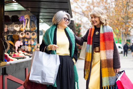 Senior women friends enjoying autumn market shopping