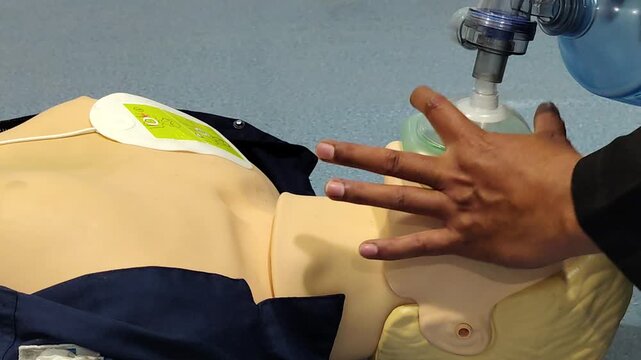 Medical student practicing rescue breathing on a cpr mannequin
