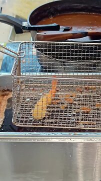 Chef lifting up ebi fry shrimp prawns from a deep fryer basket, Japanese Fast Food Kitchen Cookware, Bubbling Cooking Oil, Seafood Cuisine, Catering Industry