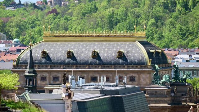 The curved roof of the National Theatre with its gilded balustrade and bronze chariot statues, Prague, Czech Republic